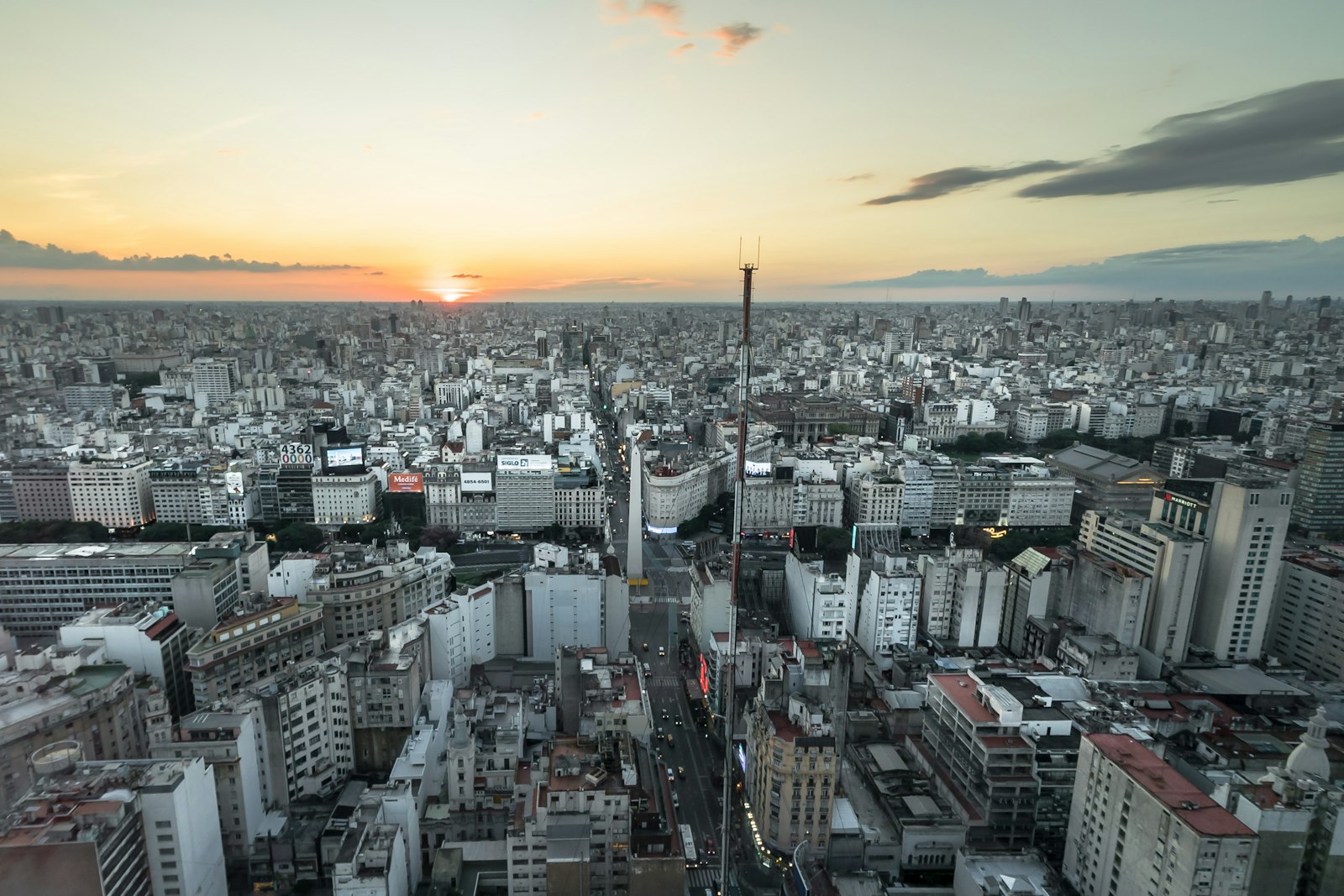 Aerial view of the Buenos Aires skyline at sunset with high-rise residential buildings.
